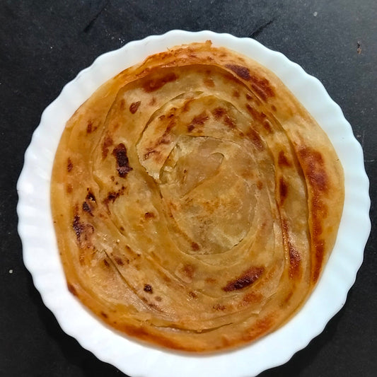Frozen Whole Wheat Chakki Paratha by chicnbe – Healthy, traditional Indian flatbread made with chakki atta, layered and ready to cook, served hot and crispy.